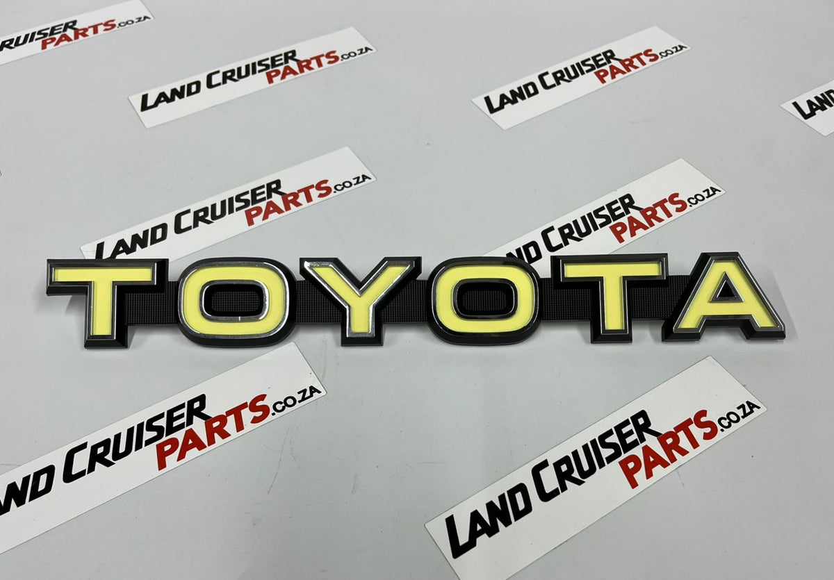Toyota Land Cruiser FJ40/45 Grill Badge / Emblem - Yellow OEM