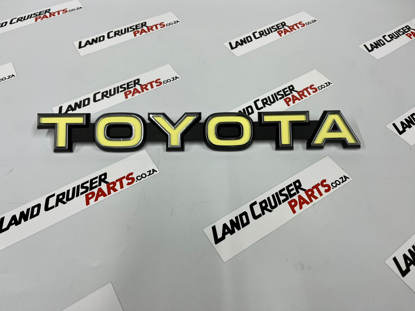 Toyota Land Cruiser FJ40/45 Grill Badge / Emblem - Yellow OEM