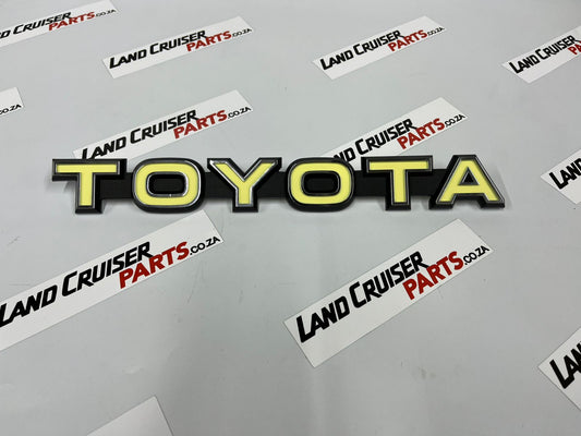 Toyota Land Cruiser FJ40/45 Grill Badge / Emblem - Yellow OEM